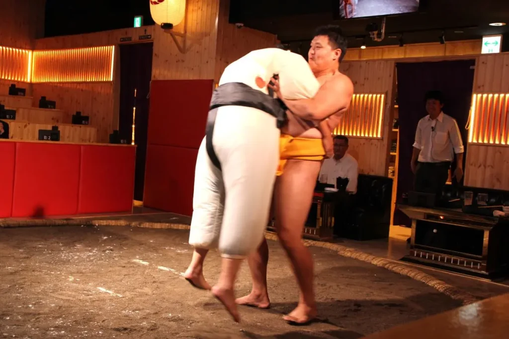 The wrestler effortlessly lifting a guest participant.