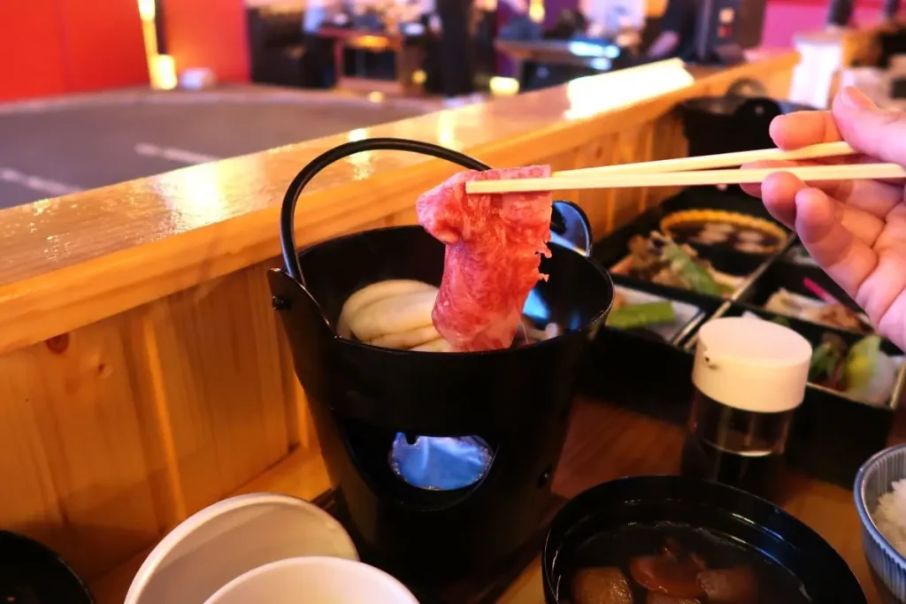 Cooking meat in a table-top pot.