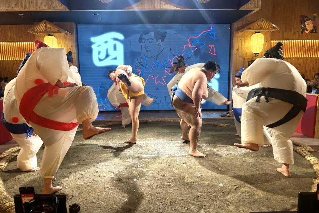 Guests joining in shiko (stamping the feet) with the wrestlers after changing into sumo costumes.