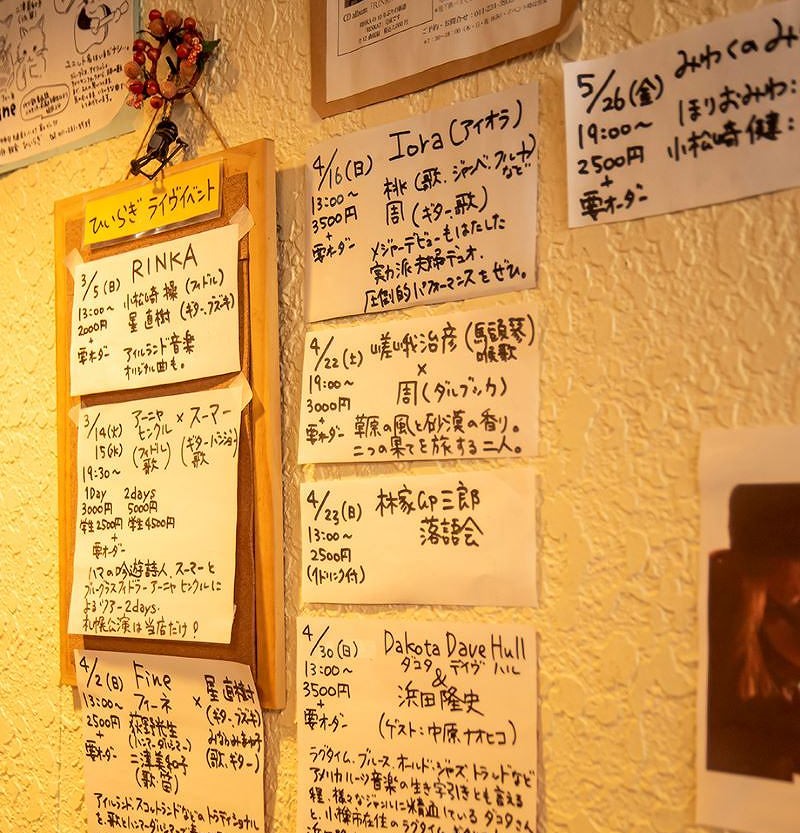 「珈琲・軽食 ひいらぎ」の店内壁に掲示されているライブイベントのお知らせ