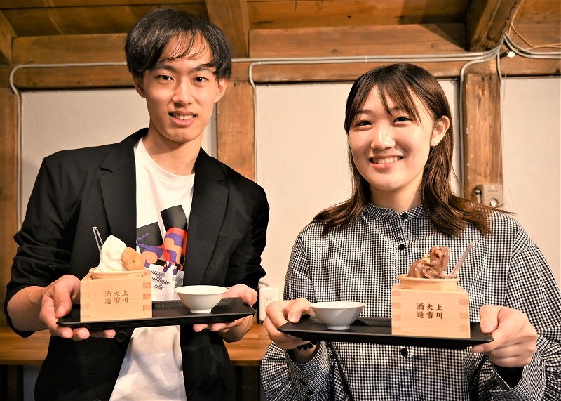 ソフトクリームと日本酒が入ったおちょこを持ってＰＲする中島さん（左）と富本さん